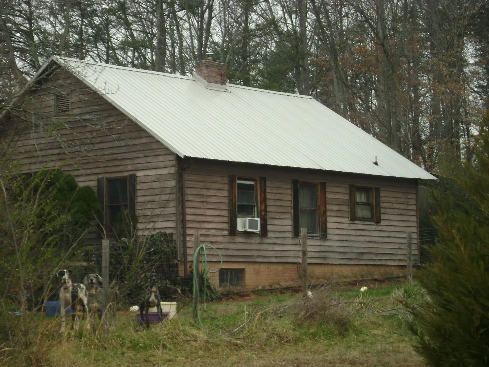 White metal roof on an old wood sided farmhouse, from a Metal Roof Installation job in Randolph